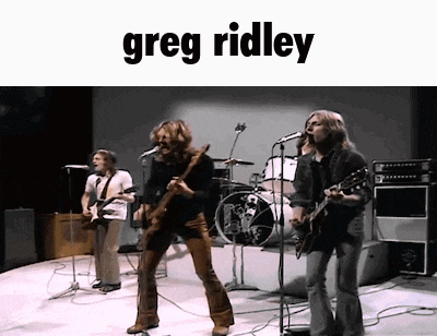 greg ridley is playing a guitar and singing on stage