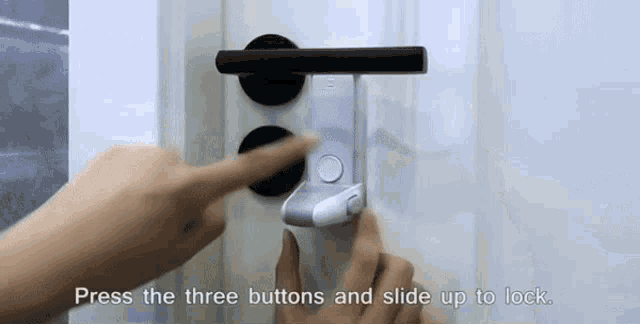 a person is pressing the three buttons and sliding up to lock