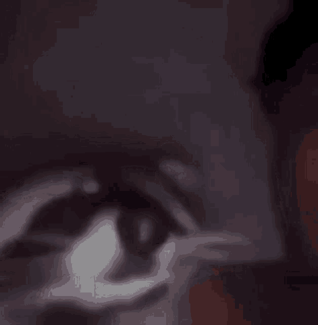 a close up of a person 's face with a shadow of a cat 's eye behind them .