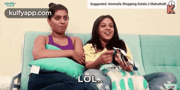 two women are sitting on a couch and one is saying lol