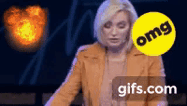 a woman is standing in front of a fireball and a yellow circle that says omg on it .