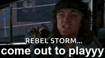 a man with a bandana on his head is sitting in a car and shouting .