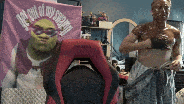 a man with shrek covered in chocolate stands in front of a pink banner that says get out of my swamp