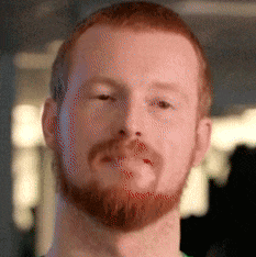 a close up of a man 's face with a beard and red hair