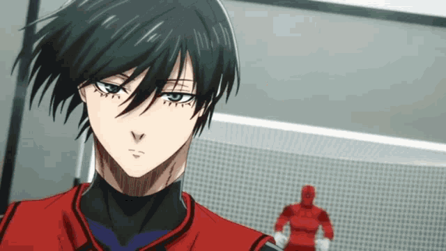 a man with black hair and blue eyes is wearing a red uniform