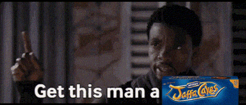 a man is holding a box of jaffa cakes