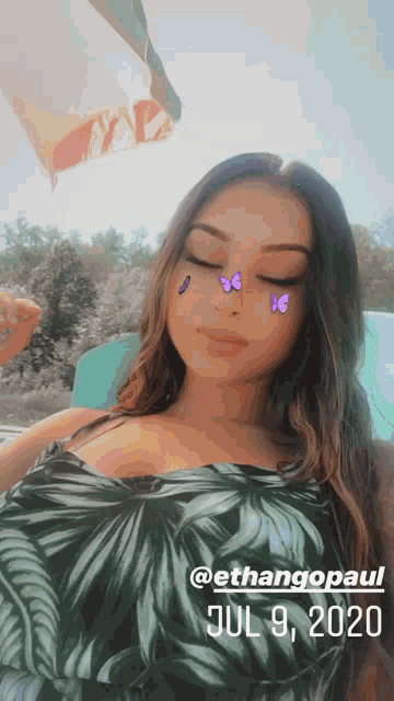 a girl with purple butterflies on her face is taken on july 9 2020