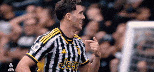 a soccer player wearing a black and white striped jeep jersey