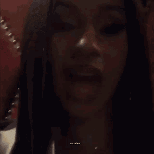 a close up of a woman 's face with her tongue out and the words " astrahwp " visible