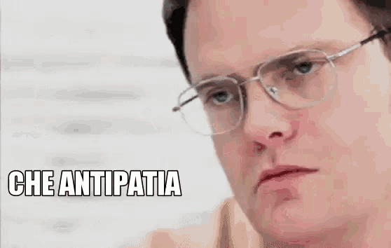 a man wearing glasses is making a funny face and says `` che antipatia '' .