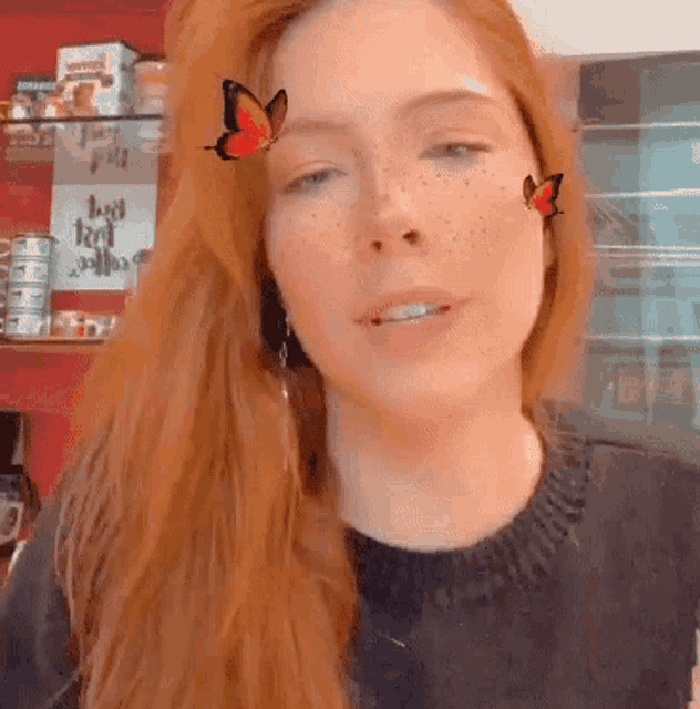 a close up of a woman 's face with a butterfly on it