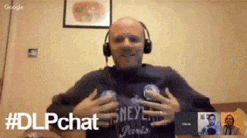 a man wearing headphones and a disney shirt is having a video call