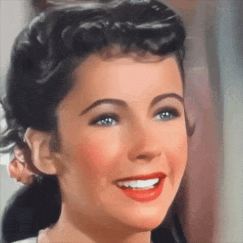 a close up of a woman 's face with red lips and blue eyes