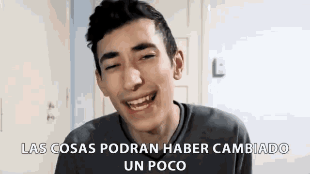 a young man is smiling with the words las cosas podran haber cambiado un poco written below him