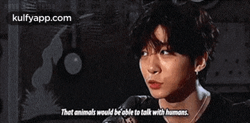 a young man is talking into a microphone and saying `` that animals would be able to talk with humans . ''
