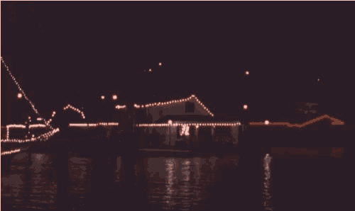 a boat is decorated with christmas lights and has the number 30 on it