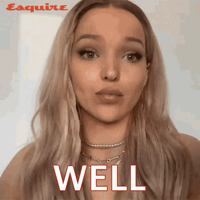 a woman with long blonde hair is wearing a necklace and says well