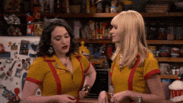 two women standing next to each other with one wearing a name tag that says nicole