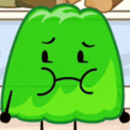a green jelly cartoon character with a sad face is standing on a table .