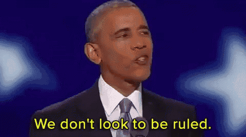 barack obama is giving a speech on a stage and says `` we don 't look to be ruled . ''