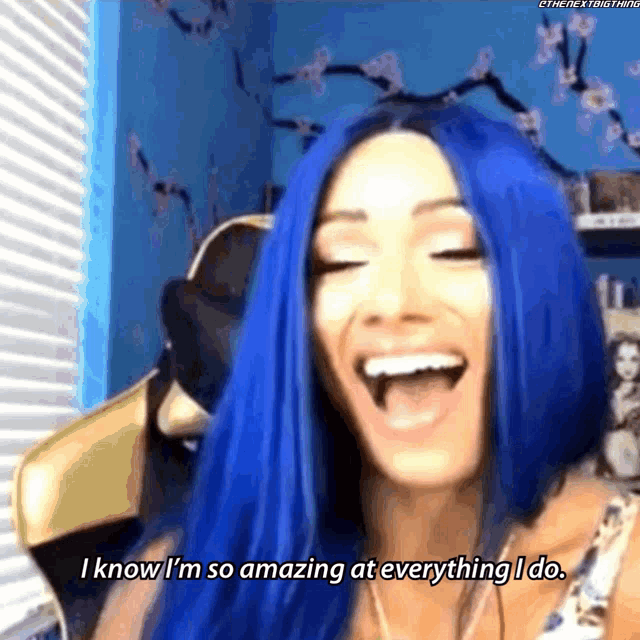 a woman with blue hair is smiling and says i know i 'm so amazing at everything i do