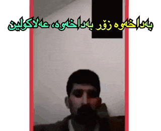 a man with a beard is talking on a phone with arabic writing behind him