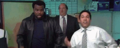 a group of men in suits and ties are standing in an office .