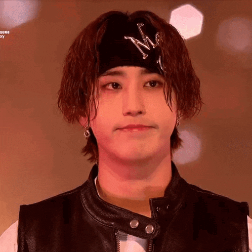 a young man wearing a headband with a letter m on it