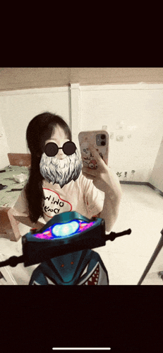 a girl wearing sunglasses and a beard takes a selfie