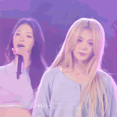 a woman with long blonde hair is wearing a blue shirt with the word heartbeat on it