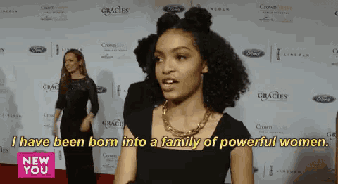 a woman on a red carpet with the words " i have been born into a family of powerful women " on the bottom
