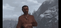 a man with a beard is standing in front of a mountain .