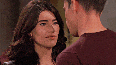 a man and a woman looking at each other with their eyes closed