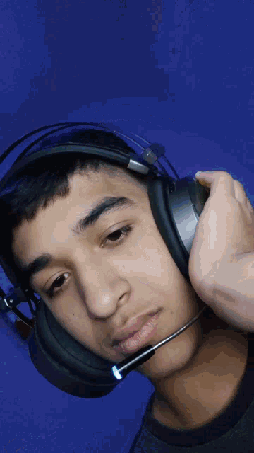 a young man wearing headphones with a microphone attached to his ear