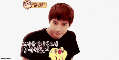 a young man is making a funny face while wearing a black t-shirt .