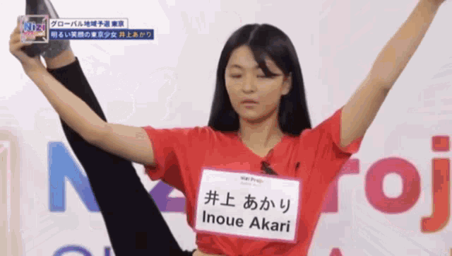 a woman in a red shirt with the name inoue akari on it