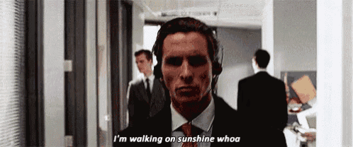 a man in a suit and tie is wearing headphones and saying i 'm walking on sunshine whoa .