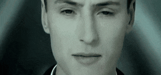 a close up of a man 's face with a serious look on his face in a black and white photo .