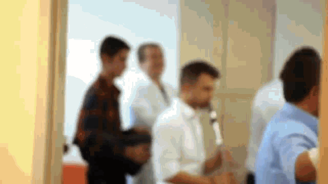 a blurry picture of people standing in a room