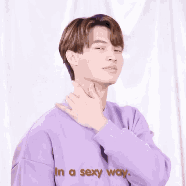 a young man wearing a purple sweater is making a funny face and says in a sexy way