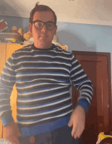 a man wearing glasses and a striped shirt