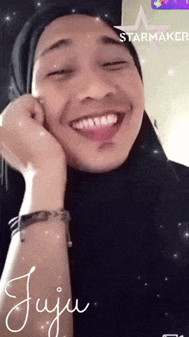 a woman wearing a hijab and a starmaker filter smiles for the camera