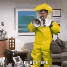 a man in a yellow hazmat suit is holding a megaphone in his mouth .