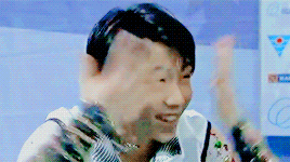 a blurry picture of a man 's face with a blue sign in the background that says ice