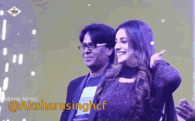 a man and a woman are standing next to each other with the words @aksharasinghcf in the lower right corner