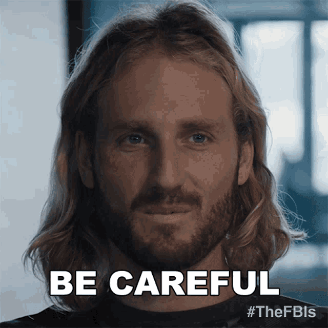 a man with long hair and a beard has the words be careful written on his face
