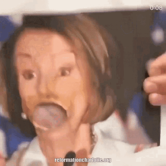 a close up of a woman 's face with a bubble in her mouth