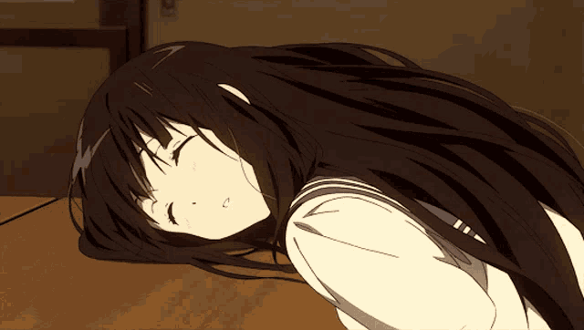 a girl with long black hair is laying on the ground with her eyes closed
