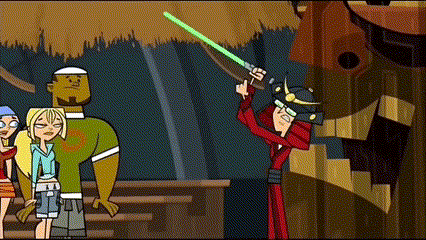 a cartoon character is holding a green light saber while standing next to a group of people .