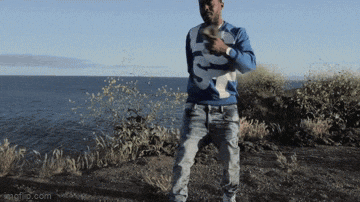a man wearing a blue and white sweater with the letter s on it